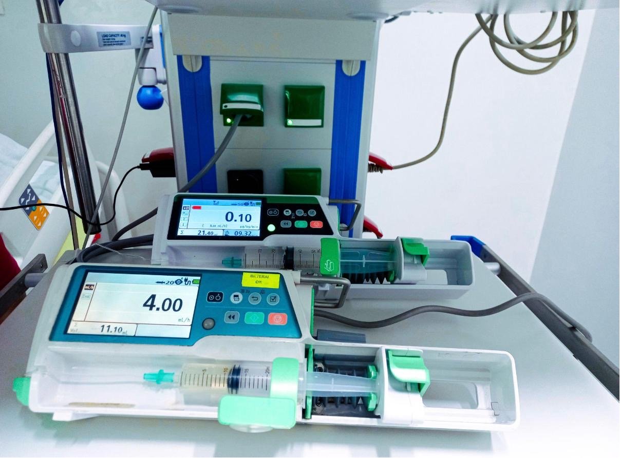 Infusion pumps and patient-monitoring equipment on a hospital cart